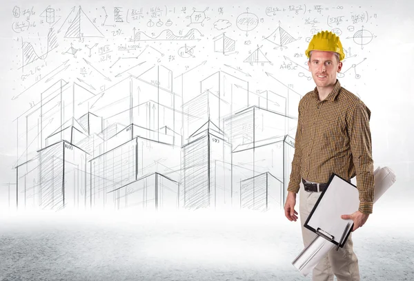 Handsome construction specialist with city drawing in background — Stock Photo, Image