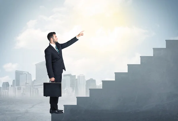 Businessman climbing up a concrete staircase concept — Stock Photo, Image