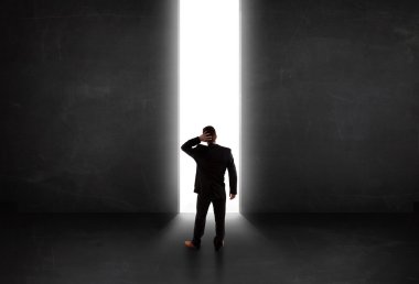 Işık tüneli açıkken duvara bakan bir iş adamı 