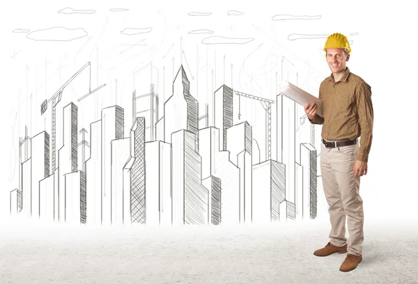 Engineer man with building city drawing in background — Stock Photo, Image