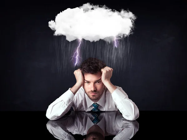 Depressed businessman sitting under a cloud — Stock Photo, Image