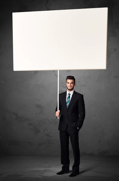 Businessman with blank whiteboard — Stock Photo, Image