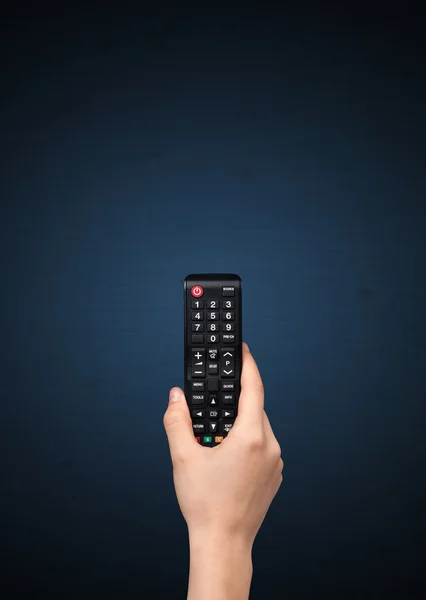 Hand with remote control — Stock Photo, Image