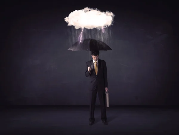 Businessman standing with umbrella and little storm cloud — Stock Photo, Image