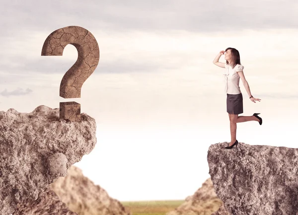 Businesswoman on rock mountain with a question mark — Stock Photo, Image