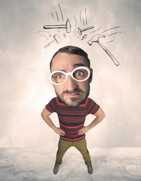 Big head person with drawn hammers — Stock Photo, Image