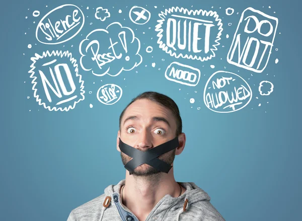 Young man with glued mouth and thought clouds — Stock Photo, Image