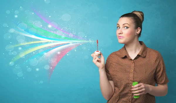 Hermosa chica soplando abstracto colorido burbujas y líneas —  Fotos de Stock