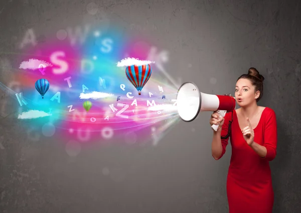 Girl shouting into megaphone and abstract text and balloons come — Stock Photo, Image