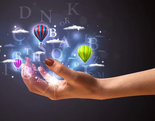 Letters and balloons in the hand of a woman — Stock Photo, Image