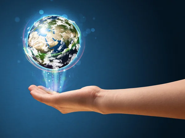 Woman holding a glowing earth globe — Stock Photo, Image