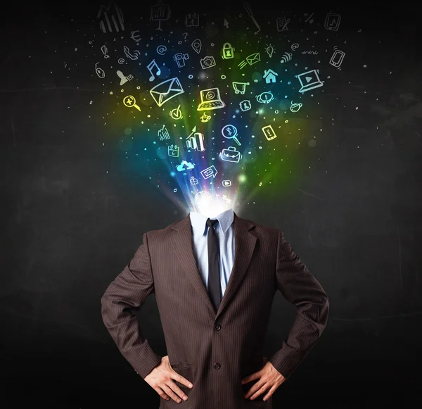 Business man with glowing media icons exploding head — Stock Photo, Image