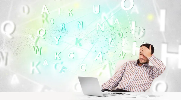 Business man at desk with green word cloud — Stock Photo, Image