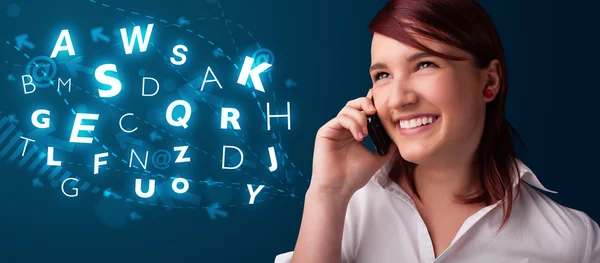 Young lady making phone call with shiny characters — Stock Photo, Image