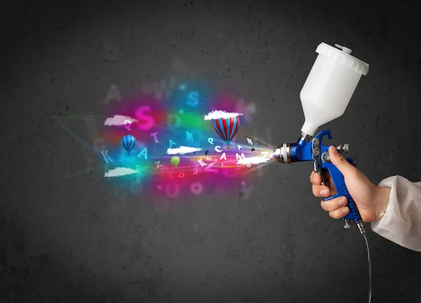 Worker with airbrush and colorful abstract clouds and balloons — Stock Image Worker with airbrush and colorful abstract clouds and balloons Stock Photo
