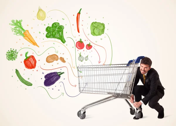 Empresario con carrito de compras con verduras —  Fotos de Stock