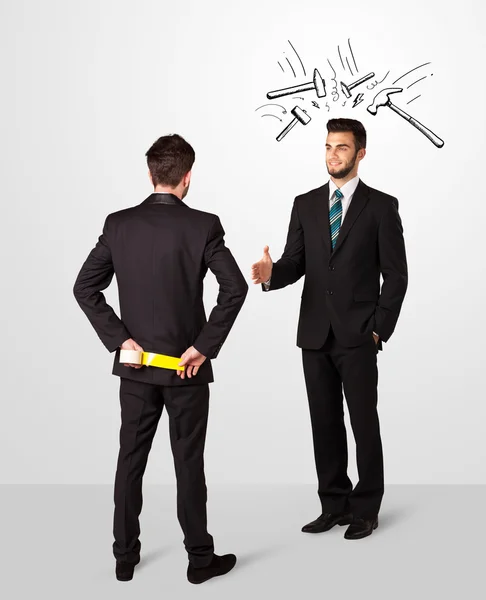 Businessman hiding a weapon — Stock Photo, Image