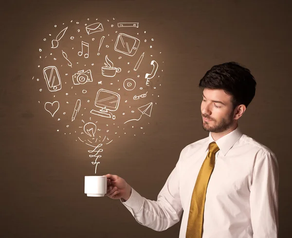 Businessman holding a white cup with social media icons — Stock Photo, Image