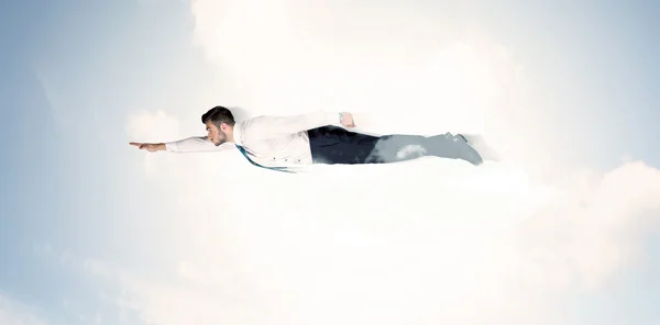 Business man flying like a superhero in clouds on the sky — Stock Photo, Image