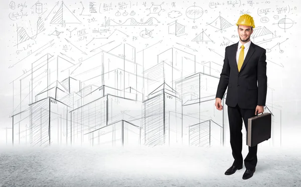 Handsome construction specialist with city drawing in background — Stock Photo, Image