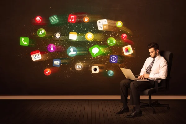 Business man sitting in office chair with tablet and colorful ap — Stock Photo, Image