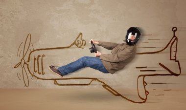 Duvara el çizimi uçak süren komik pilot.