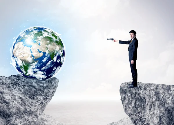 Businessman on rock mountain with a globe — Stock Photo, Image