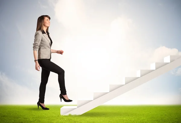 Business person climbing up on white staircase in nature — Stock Photo, Image