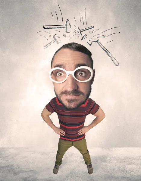 Big head person with drawn hammers — Stock Photo, Image