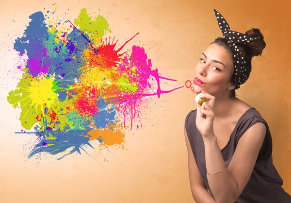 Cute girl blowing colorful splash graffiti — Stock Photo, Image