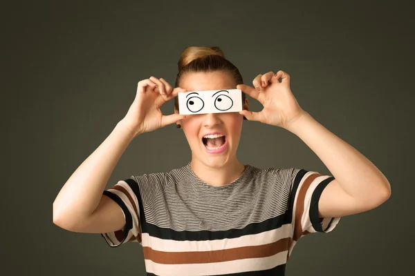 Young silly girl looking with hand drawn eye balls on paper — Stock Photo, Image