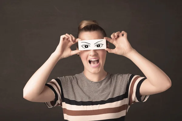 Silly youngster looking with hand drawn eye paper — Stock Photo, Image