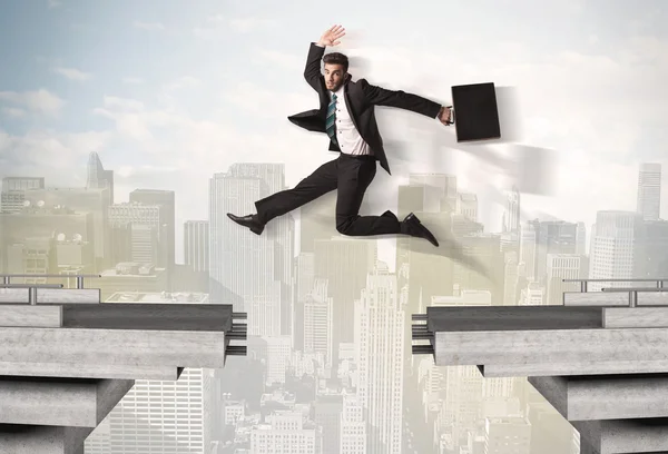 Energetic business man jumping over a bridge with gap — Stock Photo, Image