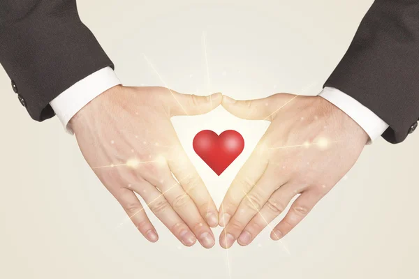 Hands creating a form with shining heart — Stock Photo, Image