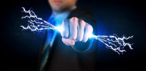 Business person holding electrical powered wires — Stock Photo, Image