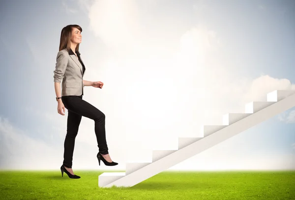 Business person climbing up on white staircase in nature Royalty Free Stock Photos