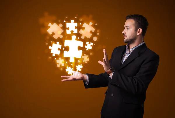 Puzzle pieces in the hand of a businessman — Stock Photo, Image