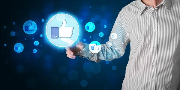 Handsome person pressing thumbs up button on modern social netwo — Stock Photo, Image