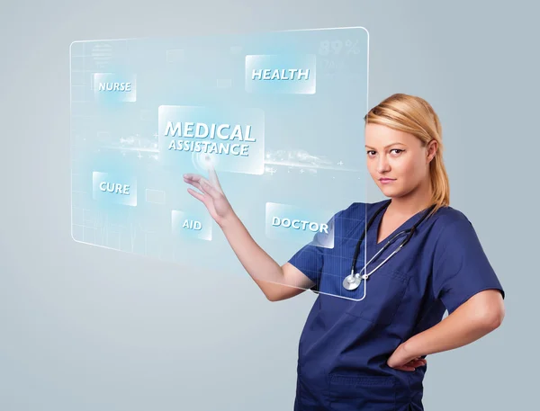 Junge Krankenschwester drückt moderne medizinische Knöpfe — Stockfoto