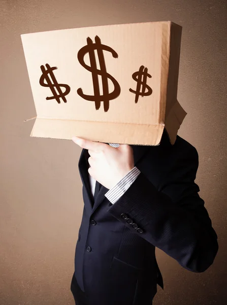 Businessman gesturing with a cardboard box on his head with doll — Stock Photo, Image