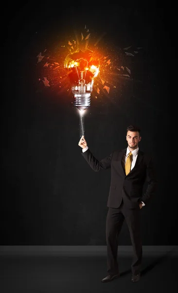 Businessman with an explosion bulb — Stock Photo, Image