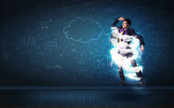 Happy business man jumping with storm cloud around him — Stock Photo, Image