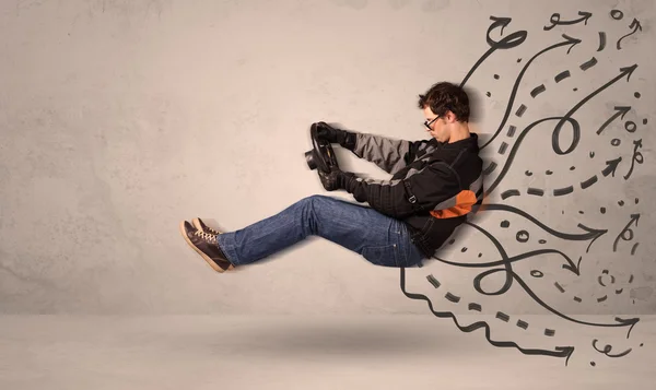 Funny man driving a flying vehicle with hand drawn lines after h — Stock Photo, Image