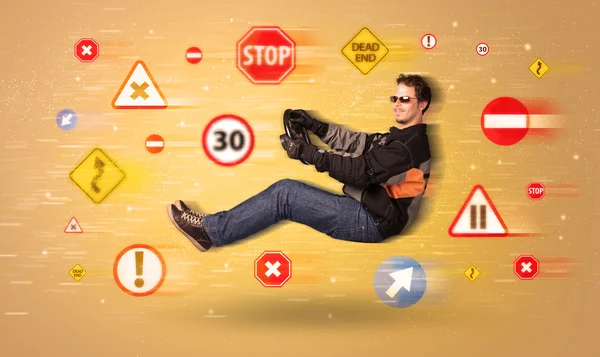 Young driver with road signs around him — Stock Photo, Image