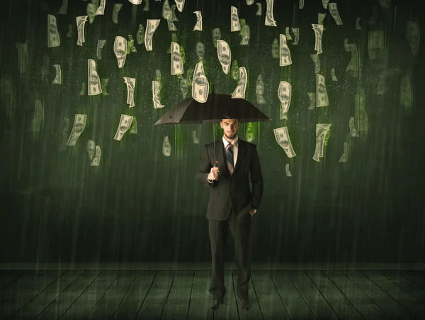Zakenman met paraplu in dollarbiljet regenconcept — Stockfoto