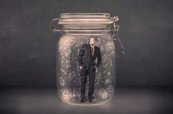 Business man captured in glass jar with hand drawn media icons c — Stock Photo, Image