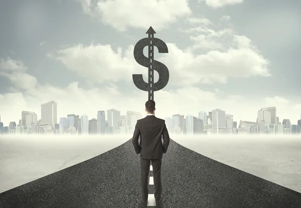 Business man on road heading toward a dollar sign — Stock Photo, Image