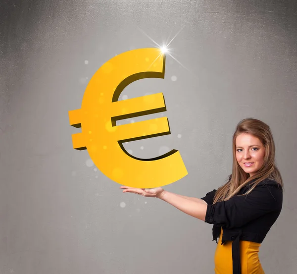 Beautiful girl holding a big 3d gold euro sign — Stock Photo, Image