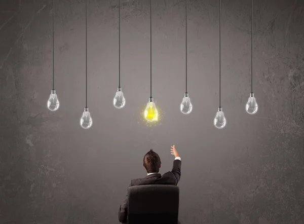 Businness guy in front of idea light bulbs concept — Stock Photo, Image