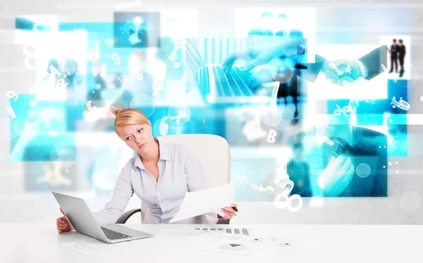 Business person at desk with modern tech images at background — Stock Photo, Image